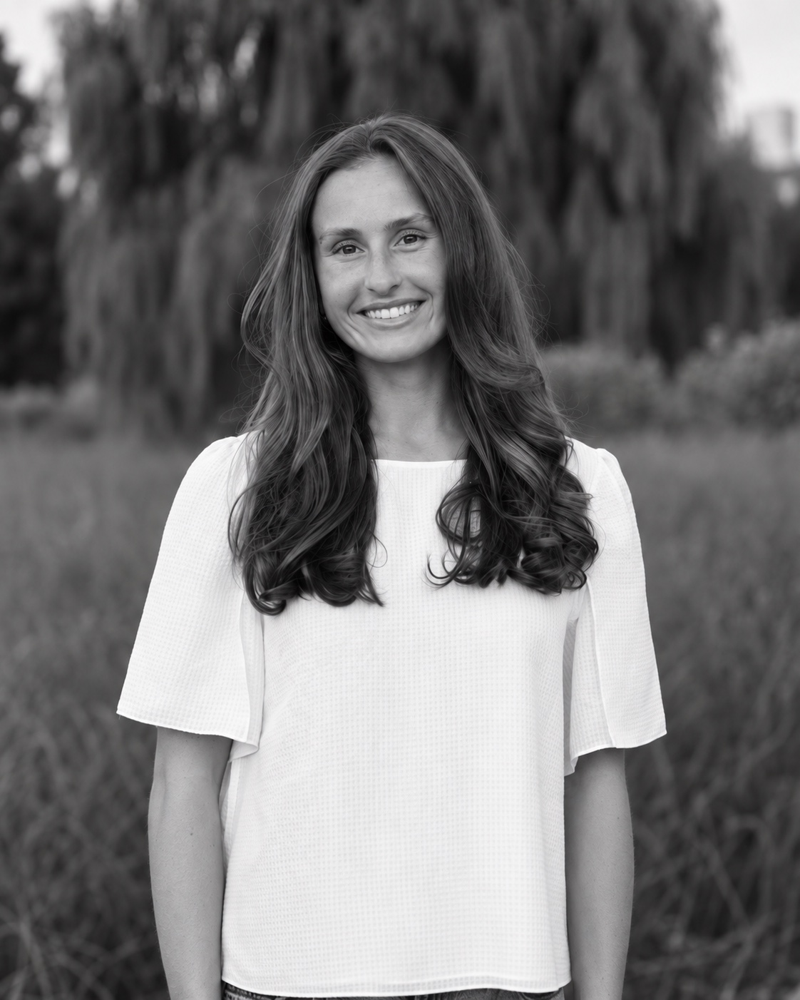 Zemra Lena, founder of Evolve Studio, smiling outdoors